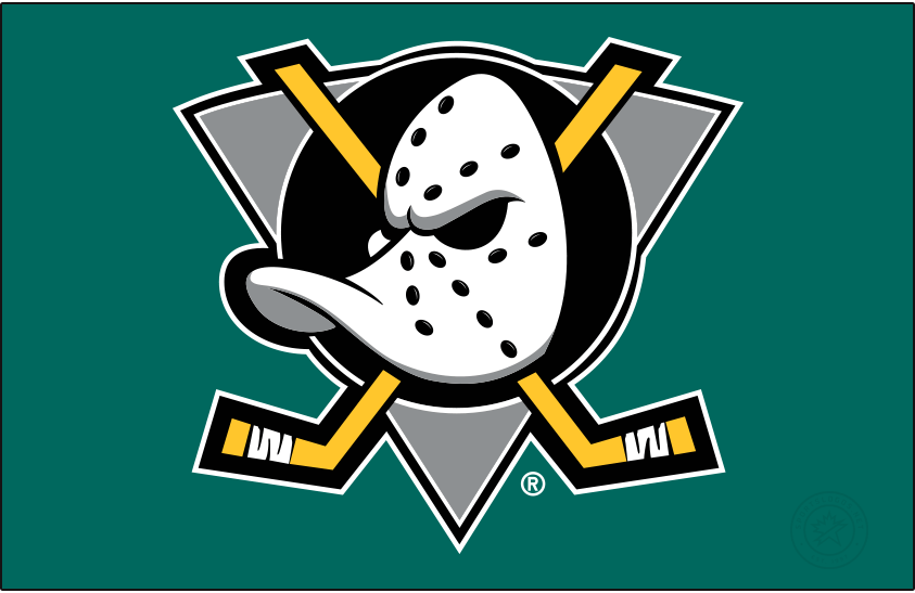 Mighty Ducks of Anaheim Logo Primary Dark Logo (1993/94-2005/06) - When used on a dark background, as it is shown here on jade green, the original Mighty Ducks of Anaheim logo featured a duck-billed goalie mask on a grey (not jade) triangle, black circle, and two crossed hockey sticks. The Mighty Ducks used this logo from 1993 through 2006 when the team's name was shortened to just Ducks. SportsLogos.Net