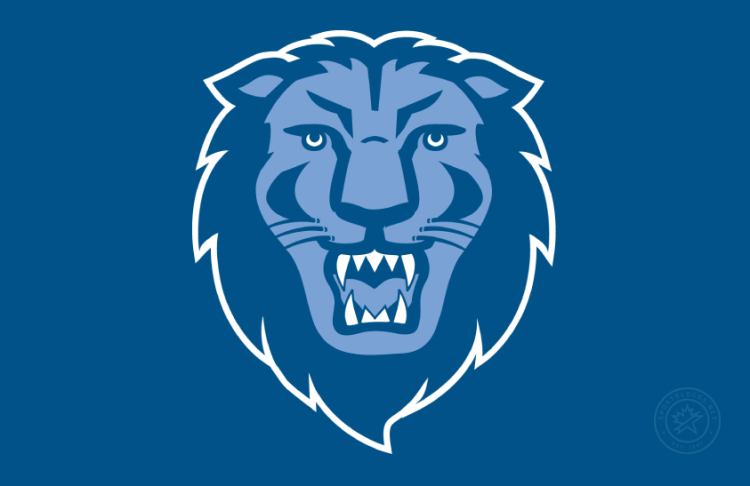 Columbia Lions Logo Primary Dark Logo (2025-Pres) - Primary logo of a front-facing lion head in Columbia Blue and navy with white outline on navy background. This originally debuted in 1997.  In 2024, Columbia Athletics adjusted its color palette to incorporate a slightly darker shade of Columbia University Blue. The new shade provides increased contrast for use in electronic and print applications, as well as enhanced consistency with performance athletic apparel textiles. SportsLogos.Net