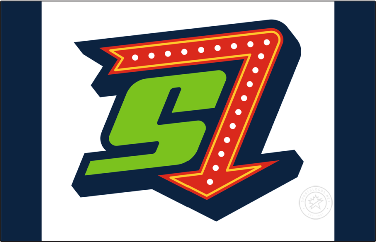 Hub City Spartanburgers Logo Cap Logo (2025-Pres) - The Hub City Spartanburgers alternate cap logo shows a green S trimmed in navy blue with a red and yellow neon sign-style arrow pointing down. Worn on the front of a navy blue cap with a white front panel. The 